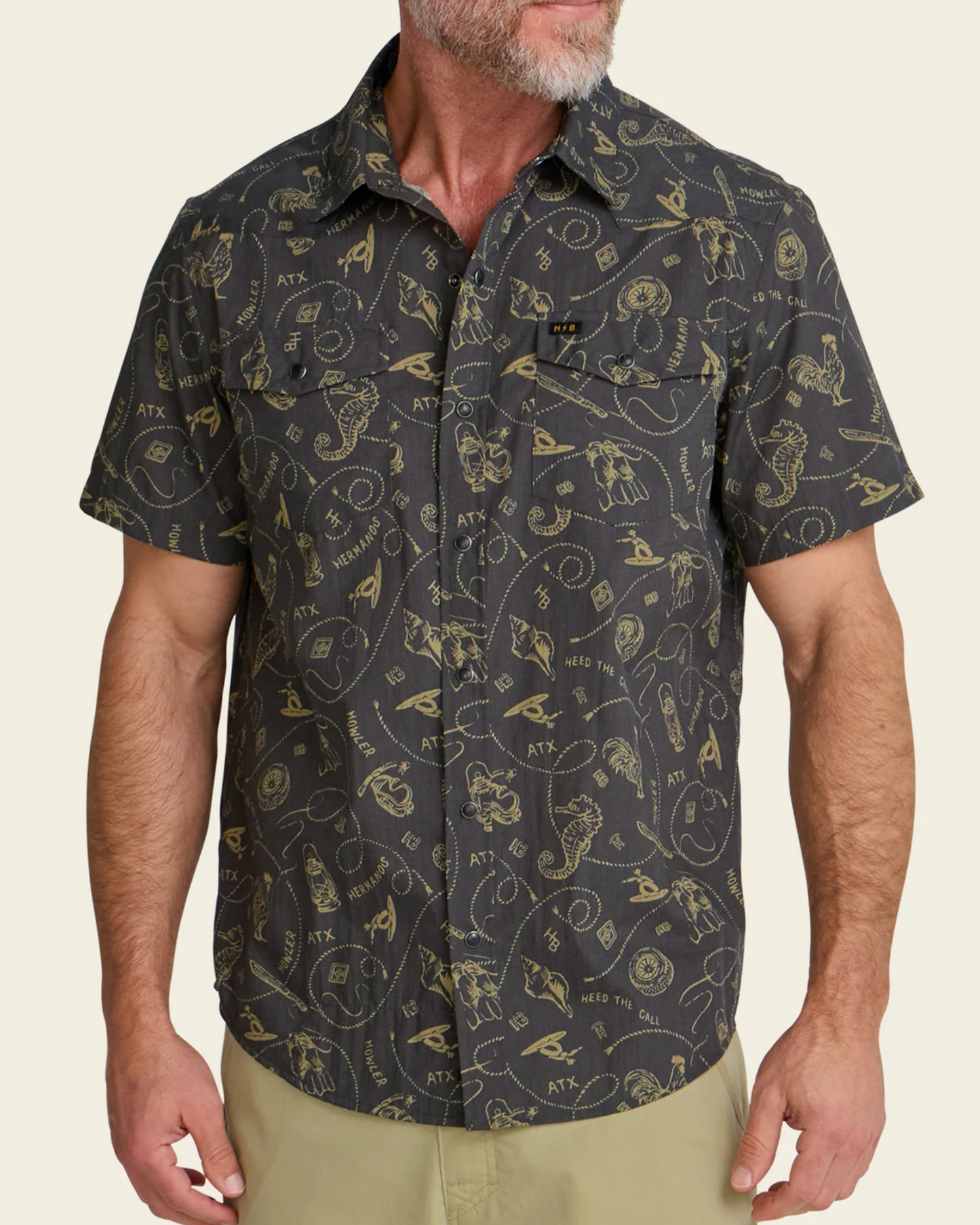 Man wearing a patterned short-sleeve shirt on a beige background