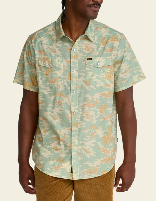 Person wearing a patterned shirt with a neutral background