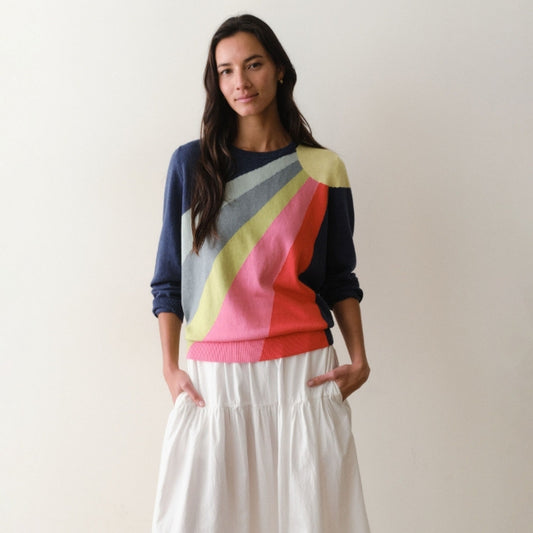Woman wearing a colorful sweater with a neutral background