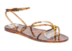 Transparent sandal with gold straps on a white background