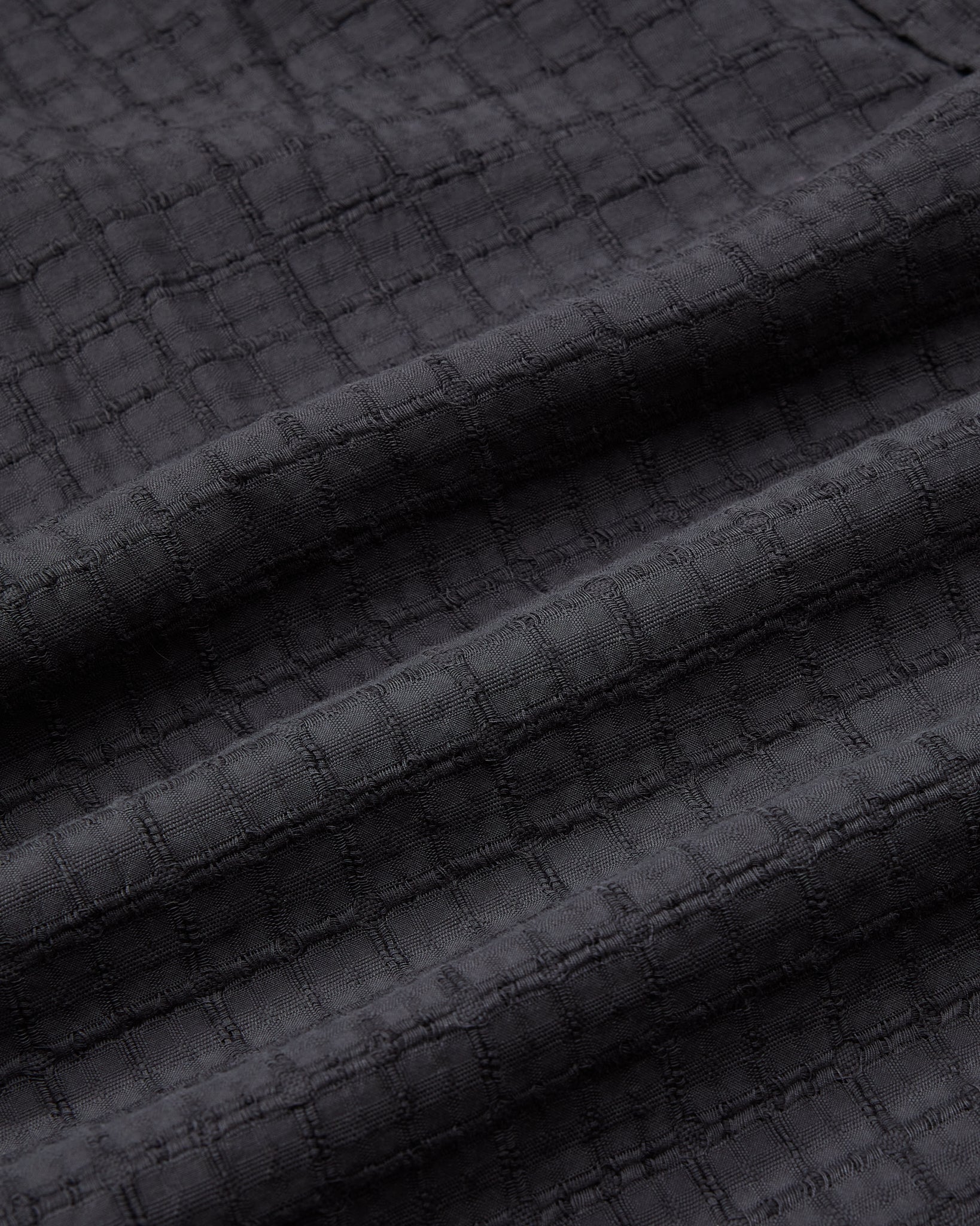 Dark textured fabric with a subtle pattern