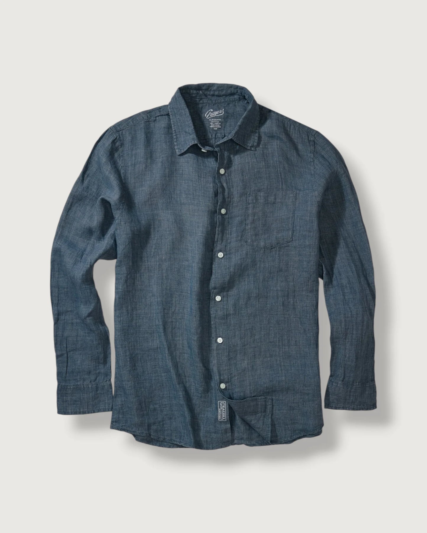 Blue denim shirt on a light gray background