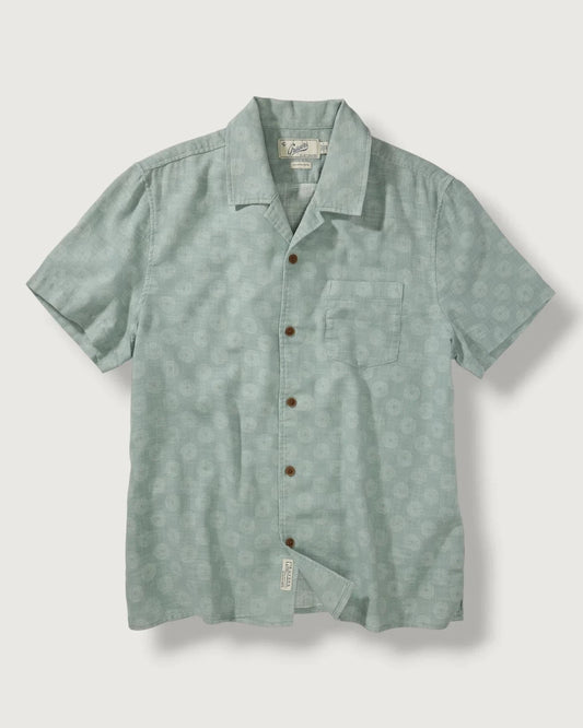 Green short-sleeve shirt with button details on a light gray background