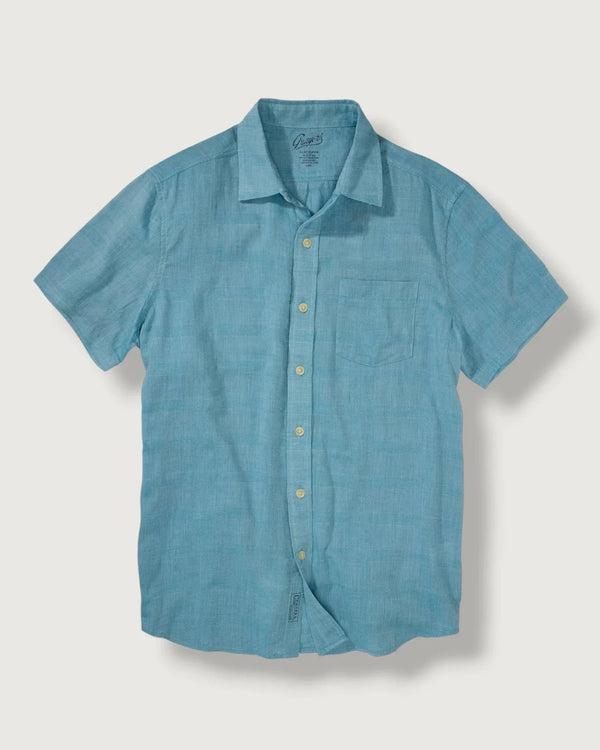 Blue short-sleeve shirt on a light gray background