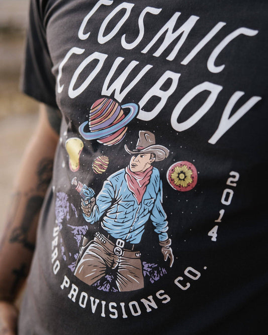 T-shirt with 'Cosmic Cowboy' design and text on a blurred background
