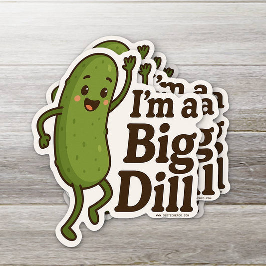 Sticker of a pickle character with text 'I'm a Bigg Dill' on a wooden surface