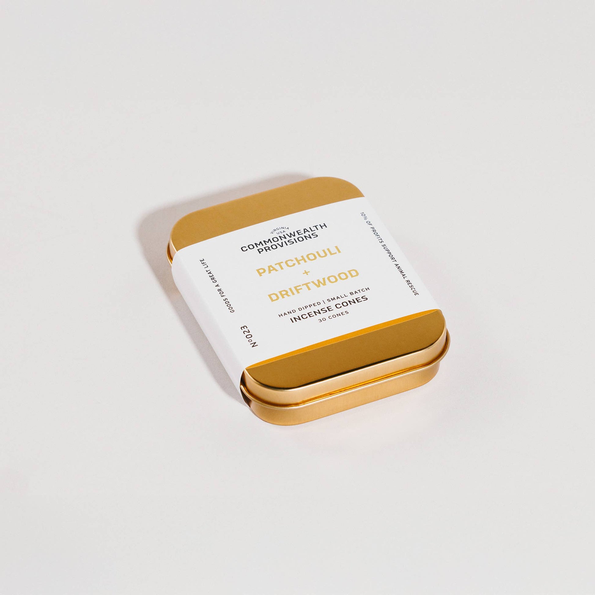 Gold and white packaging of Incense Cones on a light gray background