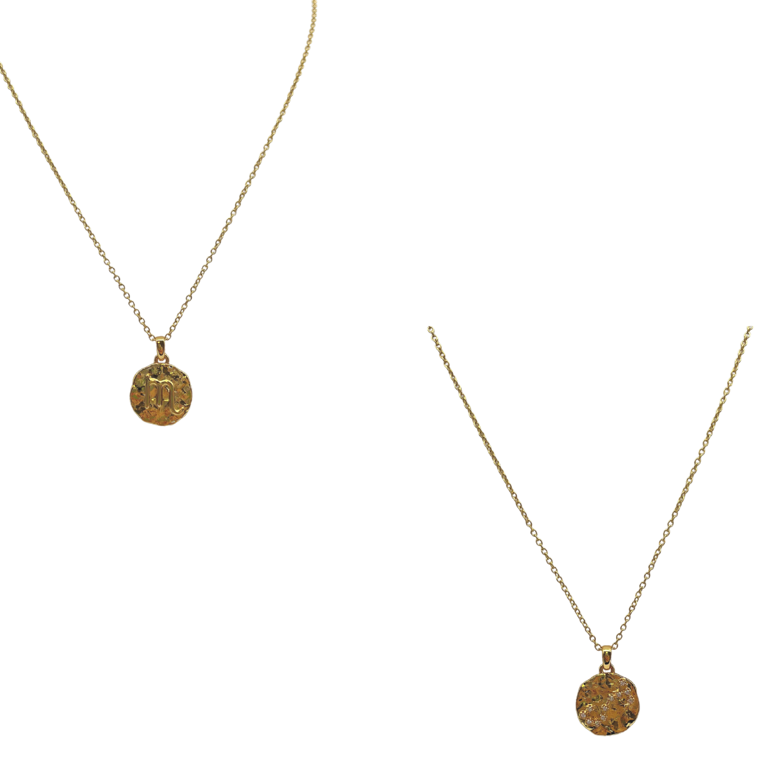 Two gold necklaces with circular pendants on a white background