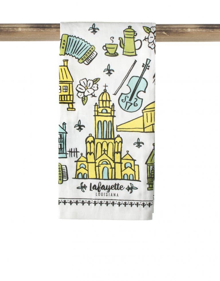 Towel with colorful illustrations of a cathedral and other landmarks on a white background
