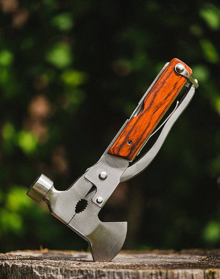 Multi-tool with wooden handle on a wooden surface, branded 'Lucky Jack'.