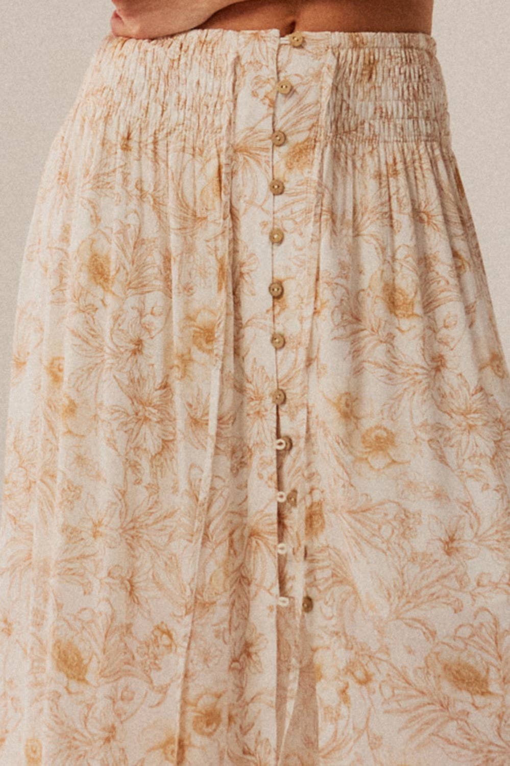 Floral patterned skirt with button details on a neutral background