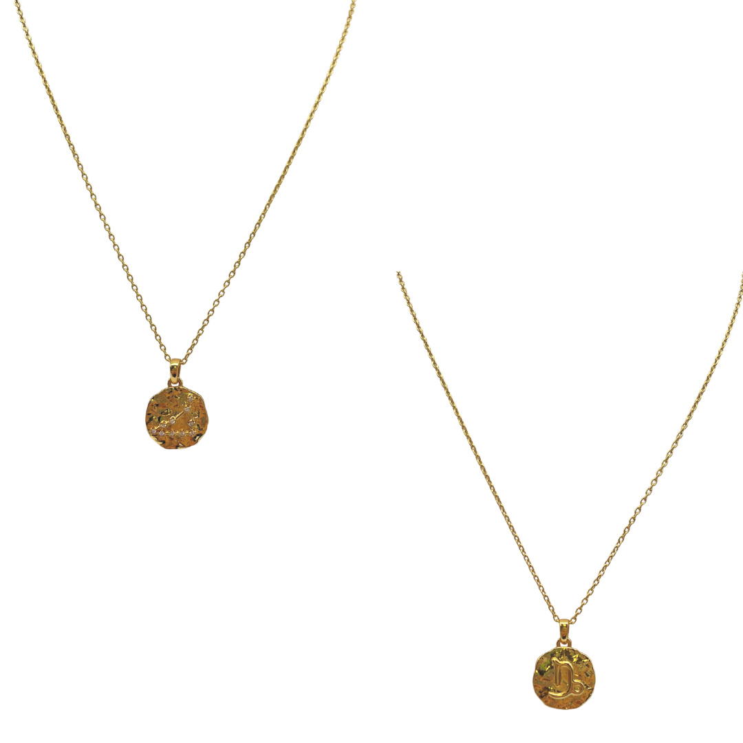 Two gold necklaces with circular pendants on a white background