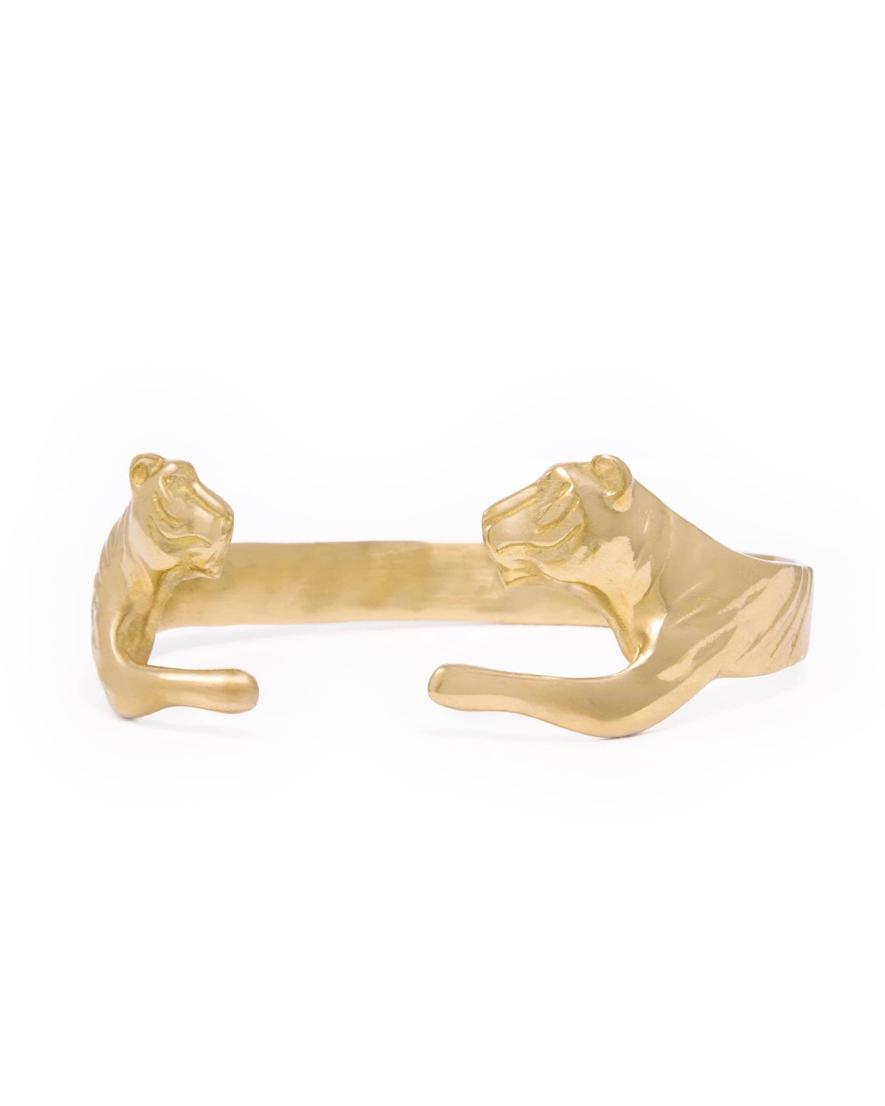A gold-tone cuff bracelet featuring sculpted tiger heads on each end, shown against a plain white background.