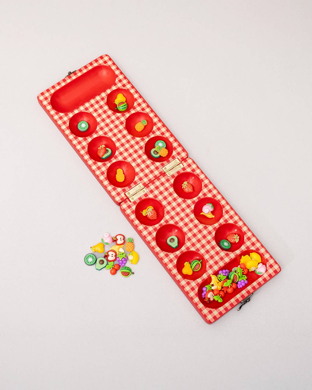 Red checkered case with colorful jelly beans on a light gray background