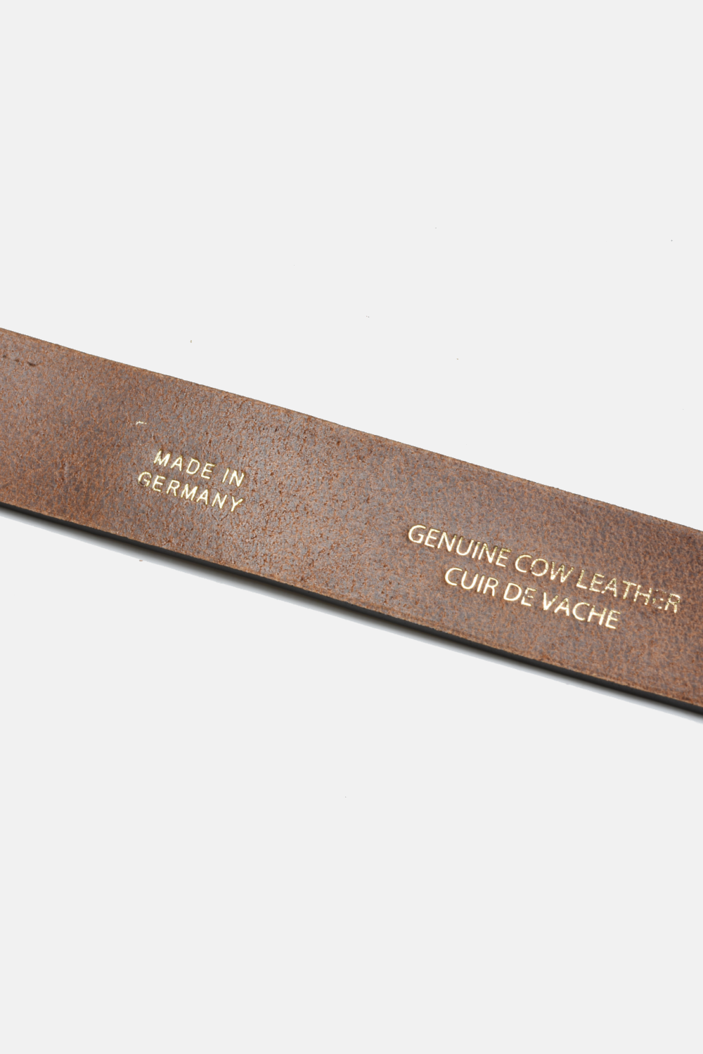 Brown leather belt with 'Made in Germany' and 'Genuine Cow Leather' text on a white background
