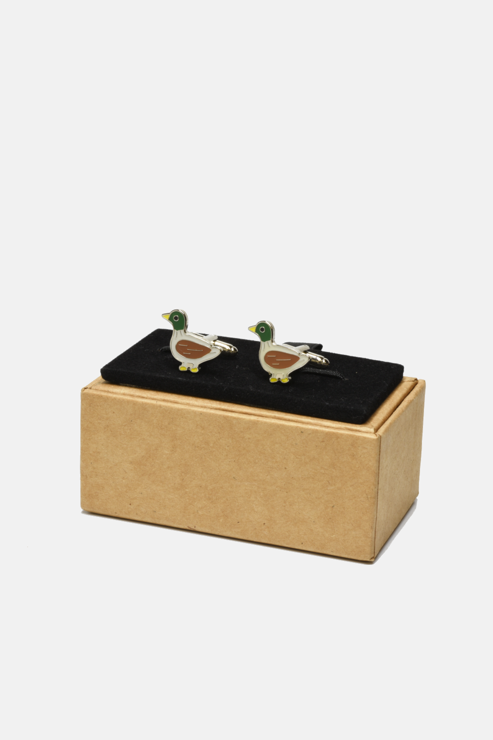 Duck-shaped cufflinks on a black box with a gold base against a white background