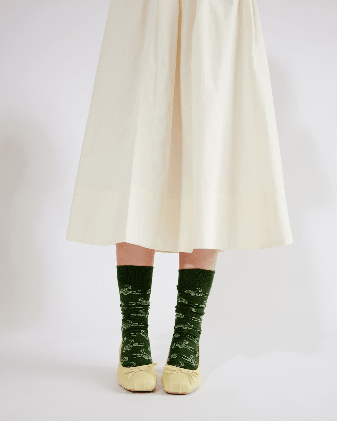Person wearing green socks with a white background