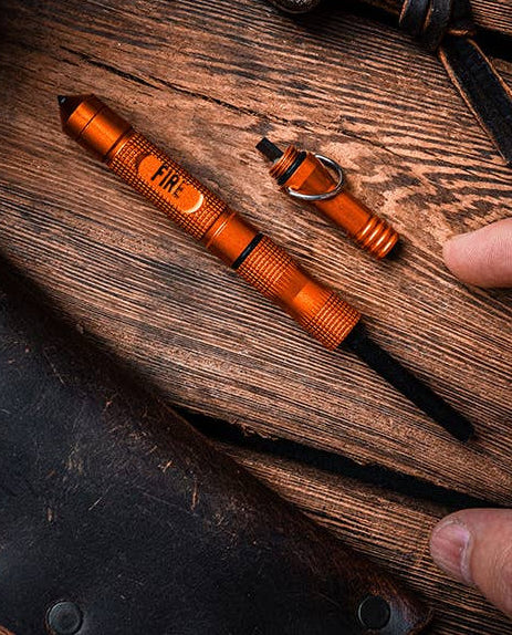 Orange pen and small tool on a wooden surface with 'Lucky Jack' branding.