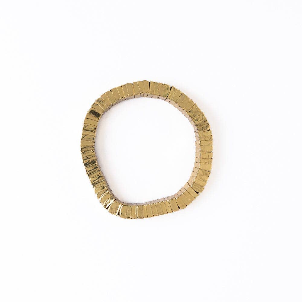 Gold ring with textured band on a white background