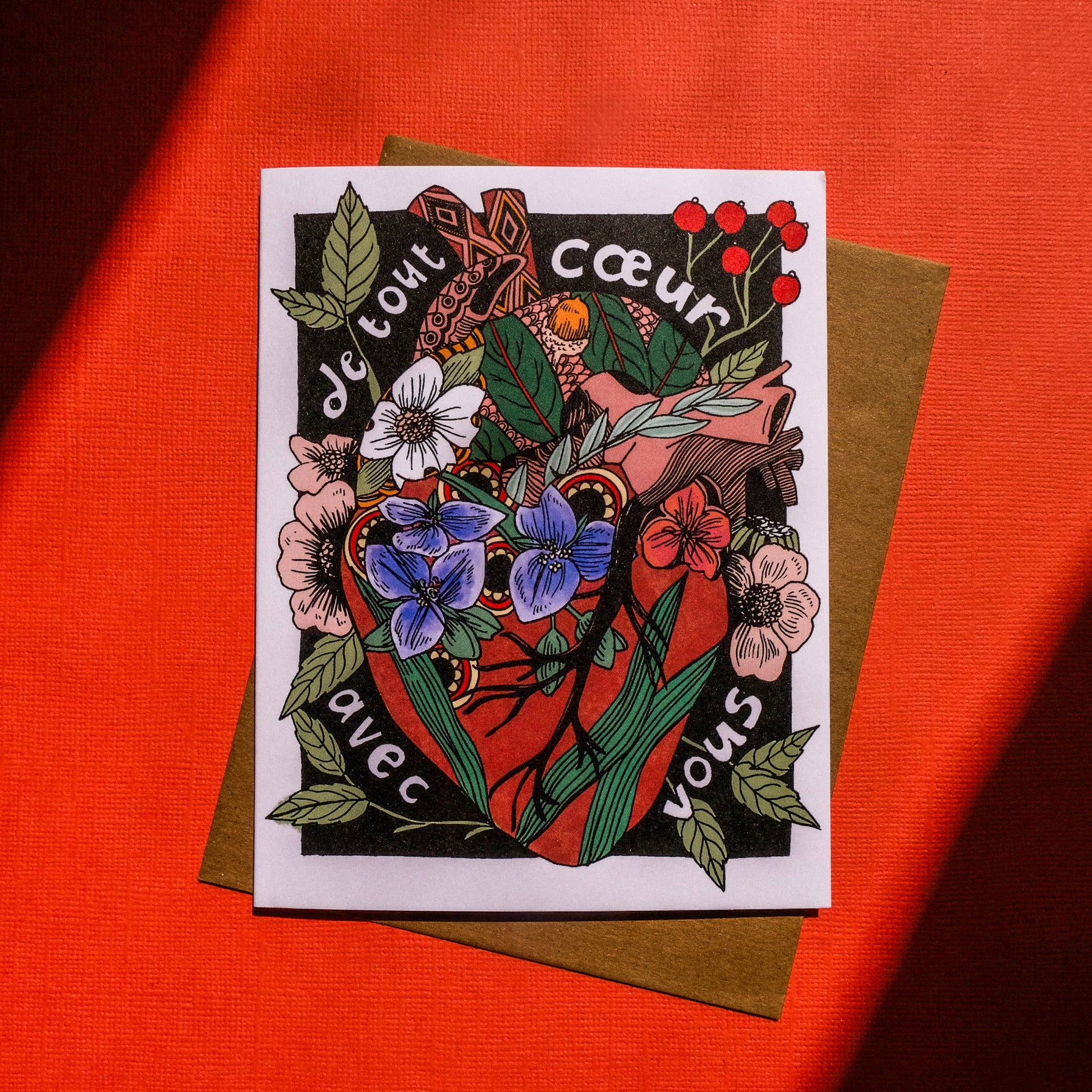 Card with floral design and heart on a red background