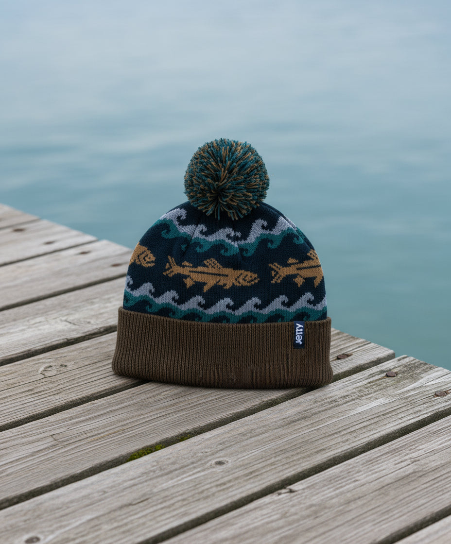 Knitted beanie with fish pattern on a dock