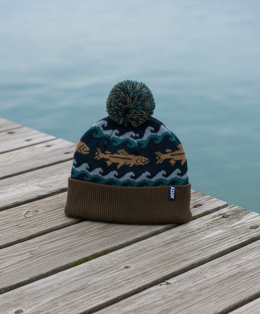 Knitted beanie with fish pattern on a dock