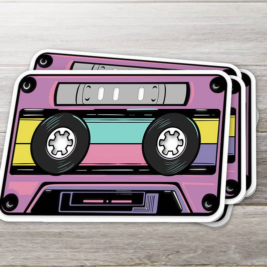 Two retro-style cassette tape coasters on a wooden surface