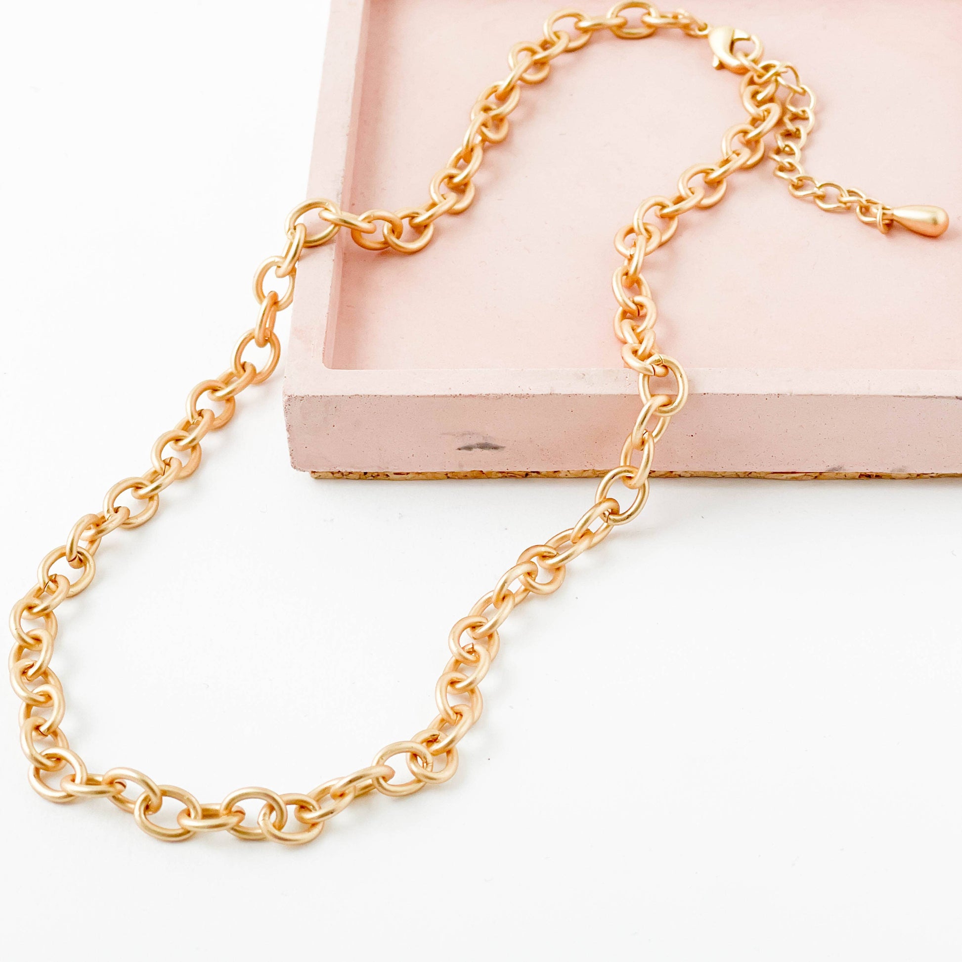 Gold chain necklace on a white background
