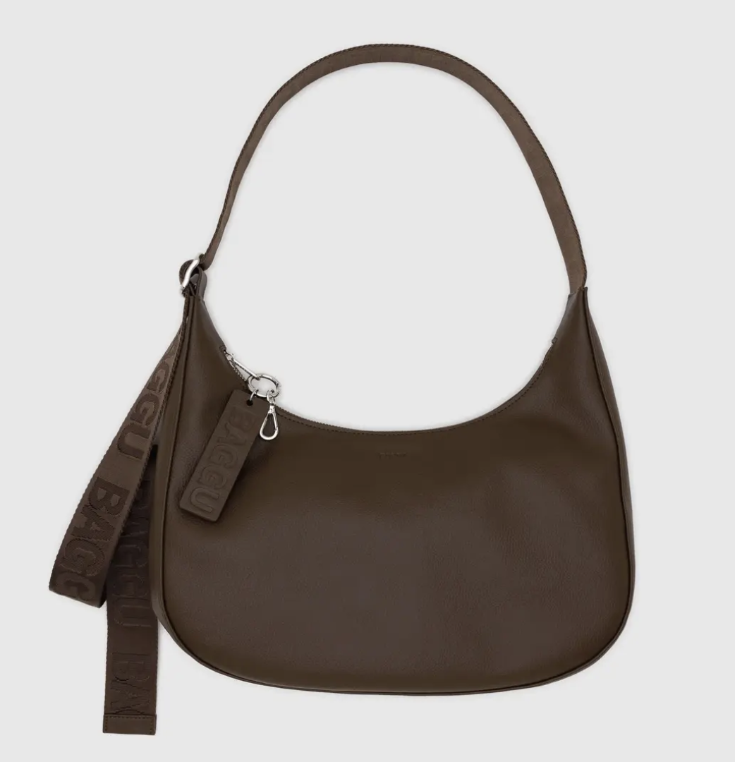 Brown handbag with a strap on a light gray background