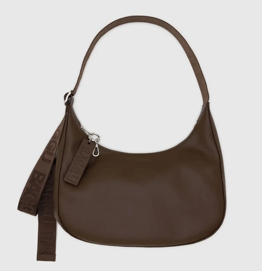 Brown handbag with a strap on a light gray background