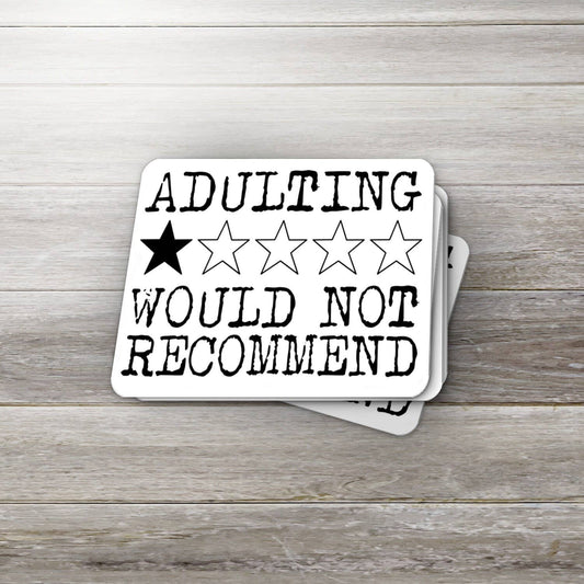 Stack of coasters with 'ADULTING WOULD NOT RECOMMEND' text and star ratings on a wooden surface