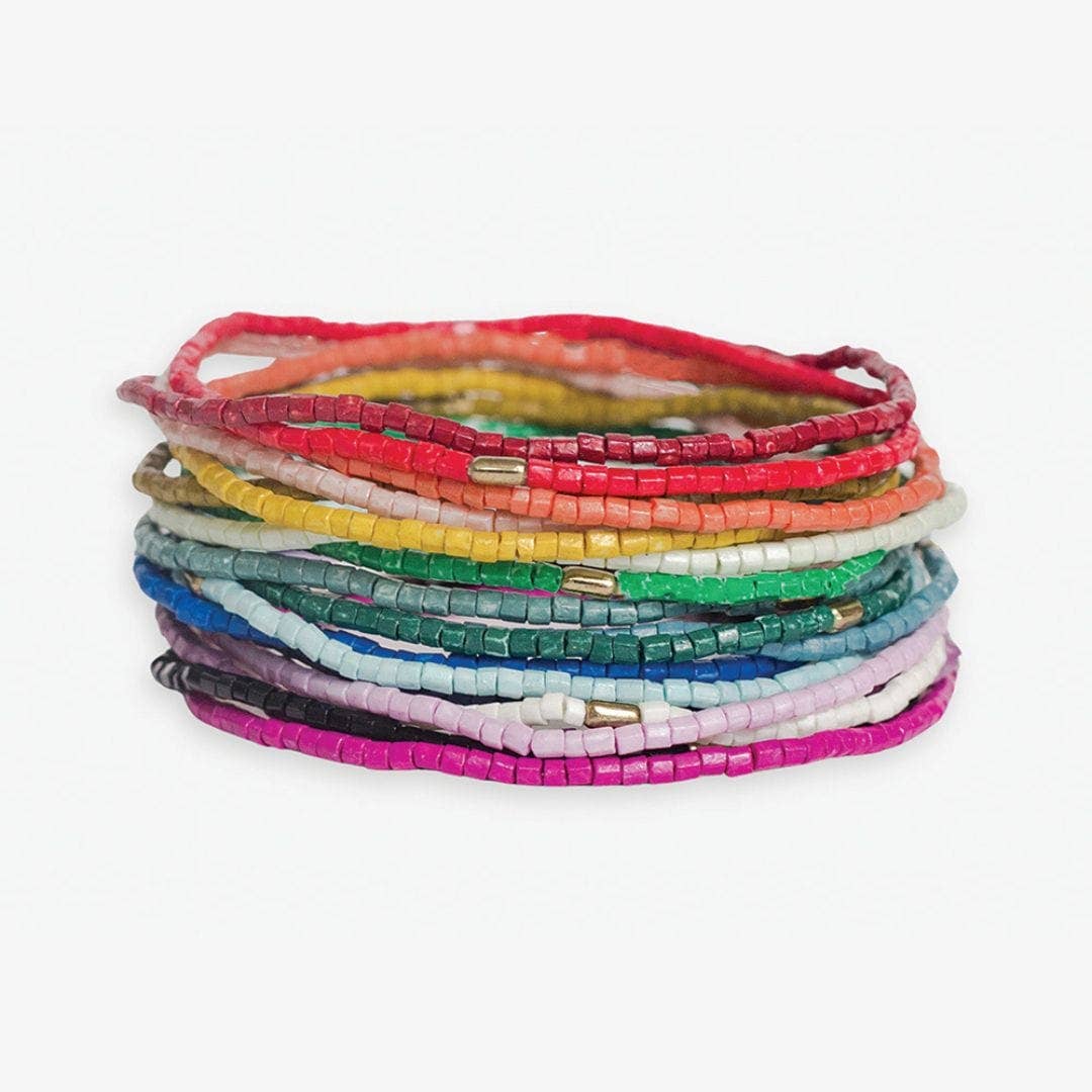 Stack of colorful beaded bracelets on a white background
