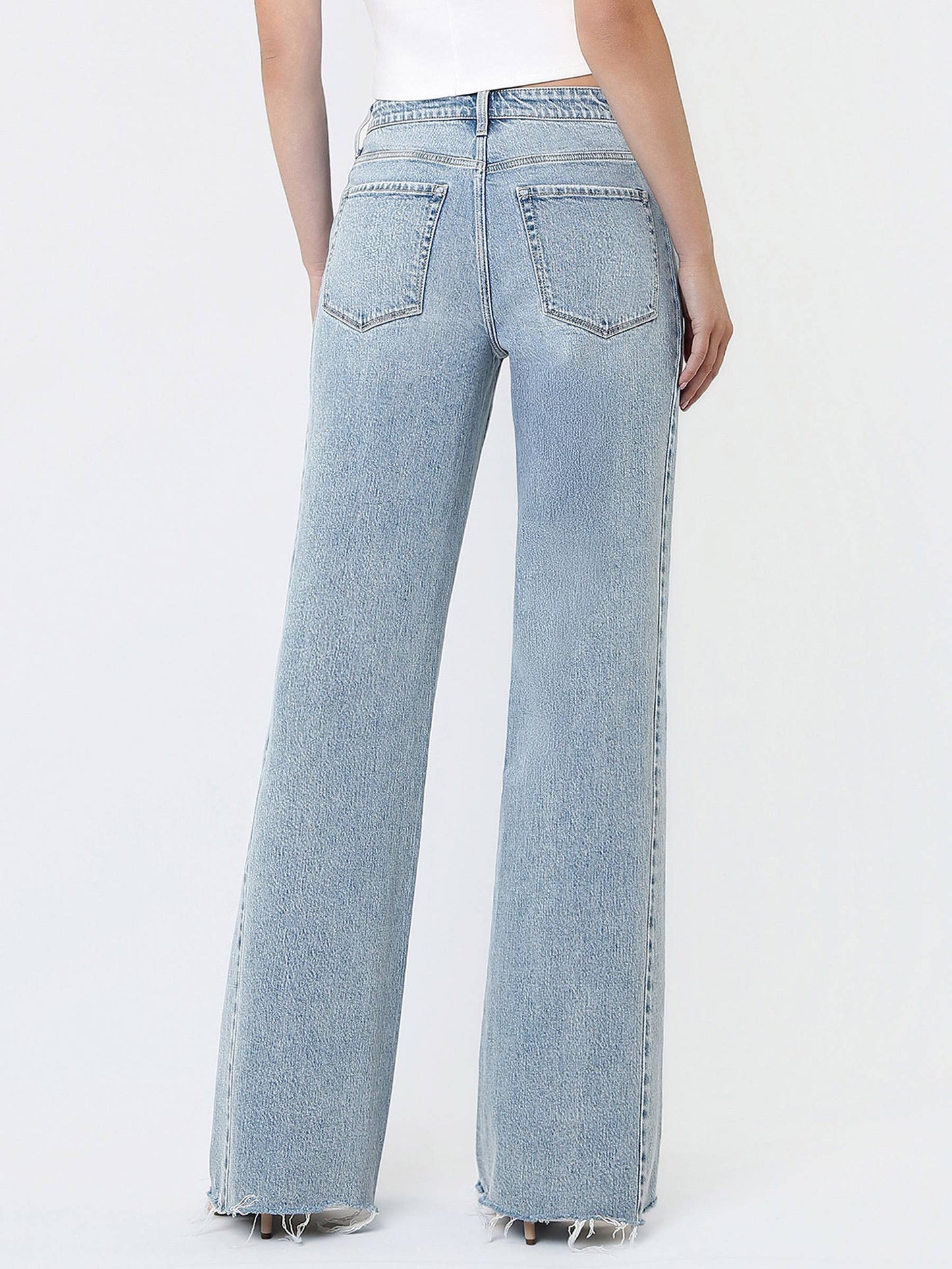 Light blue jeans worn by a person on a white background