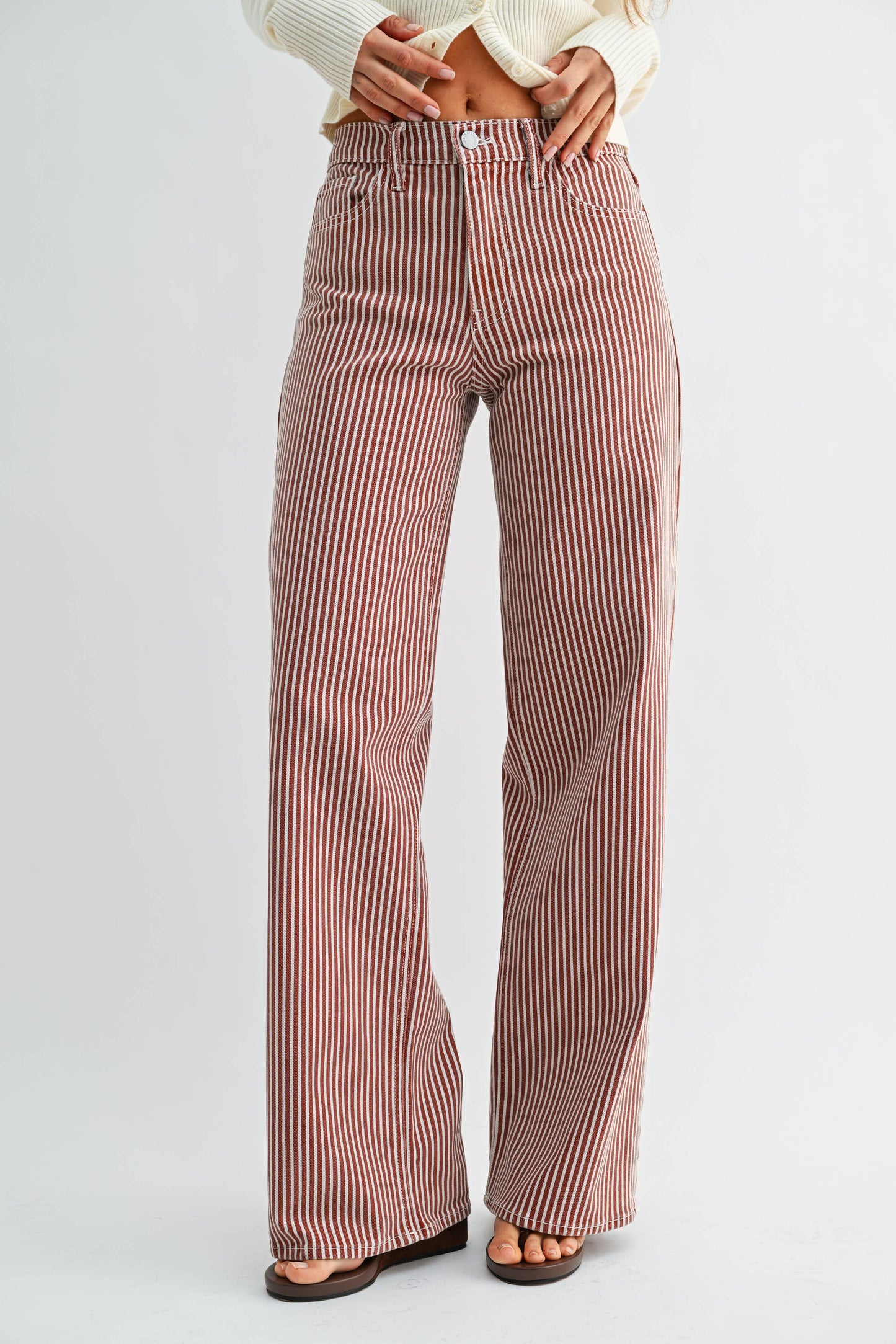 Striped pants worn by a person on a white background