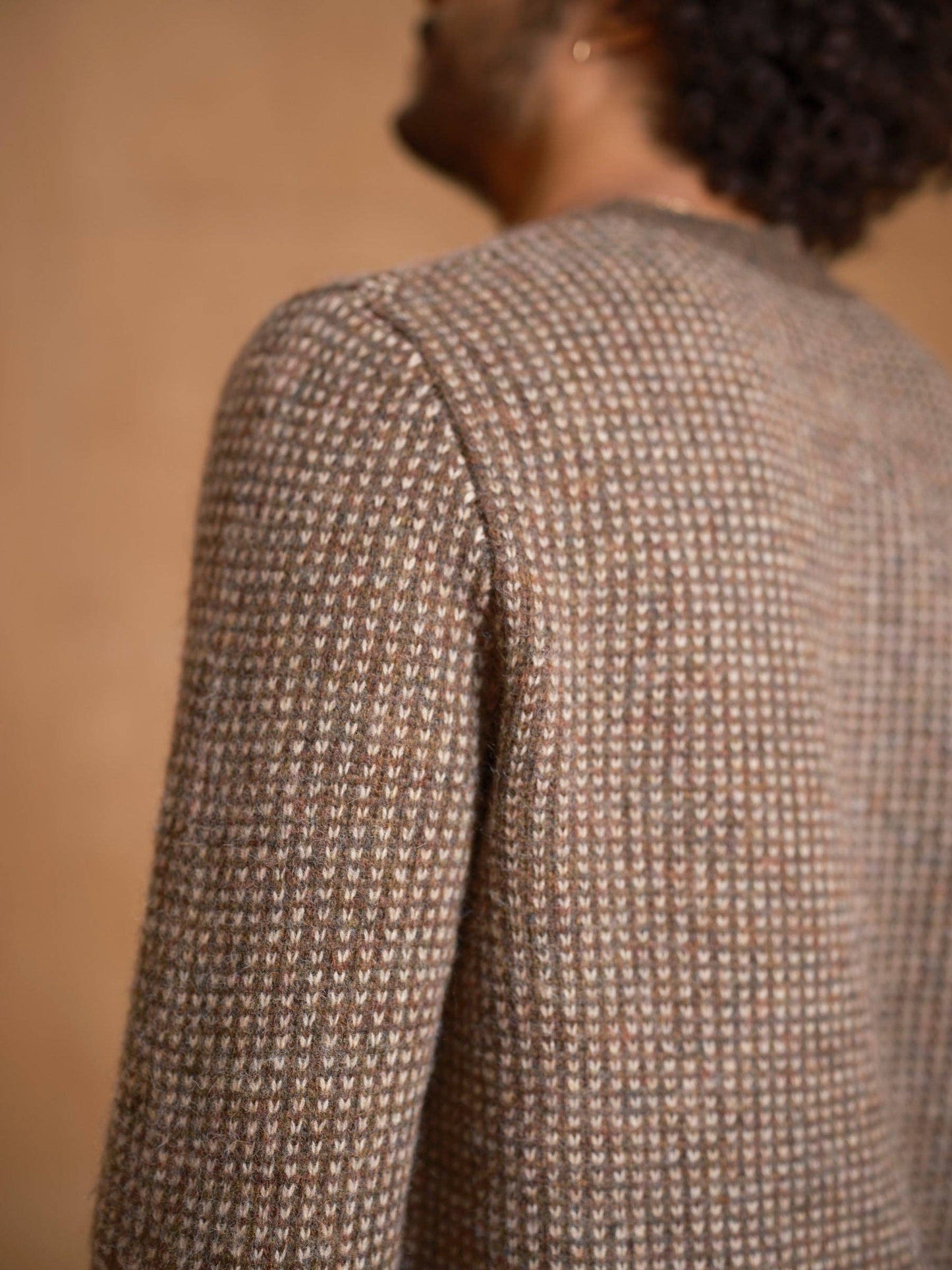 Close-up of a textured brown jacket on a blurred background