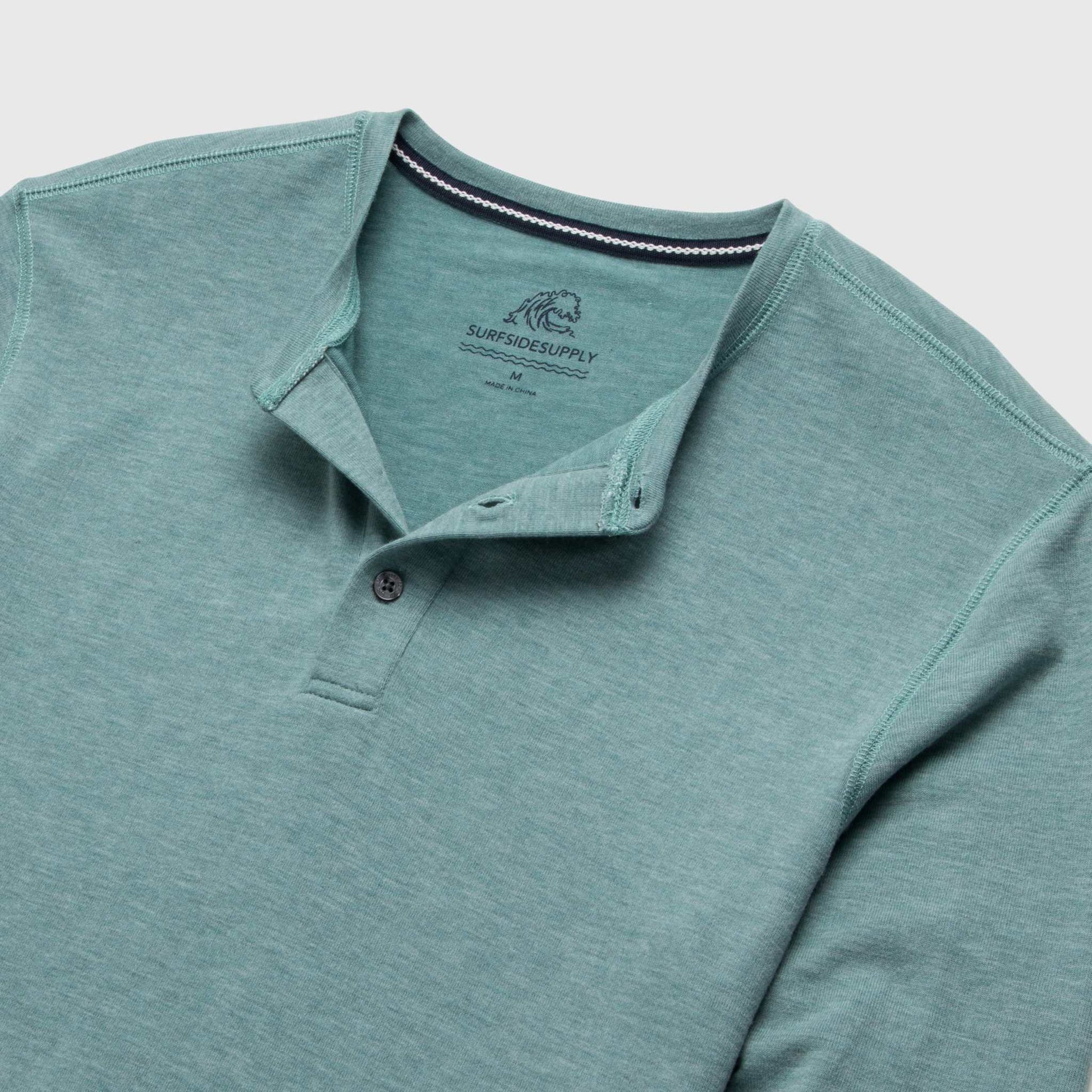 Teal long-sleeve polo shirt with collar on a light gray background