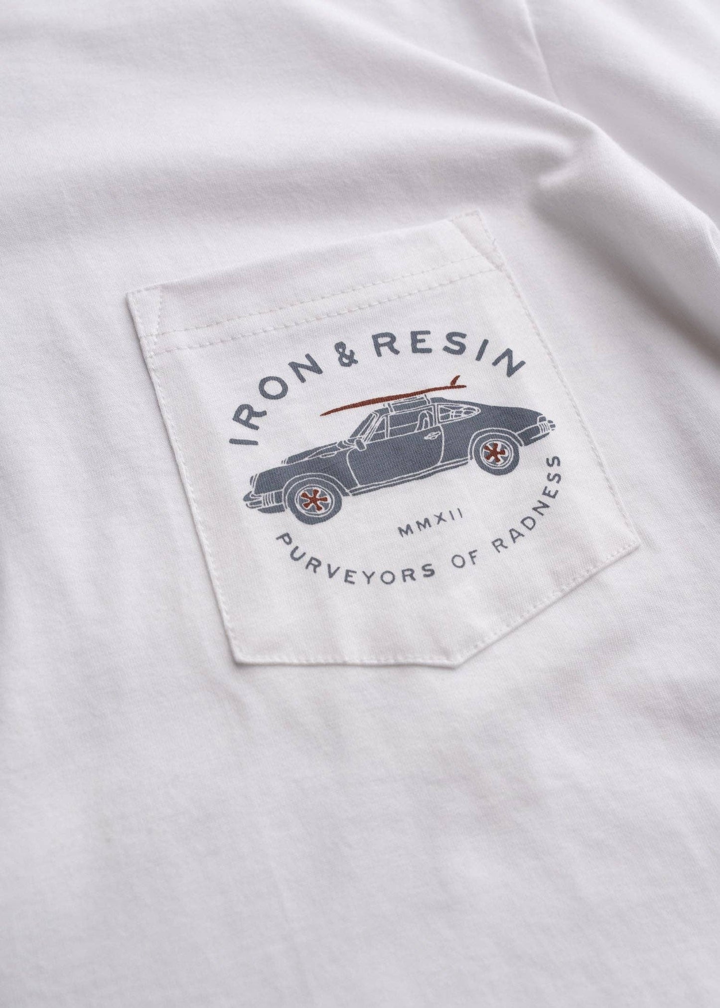 Logo on a white shirt with text 'Iron & Resin' and an illustration of a car.