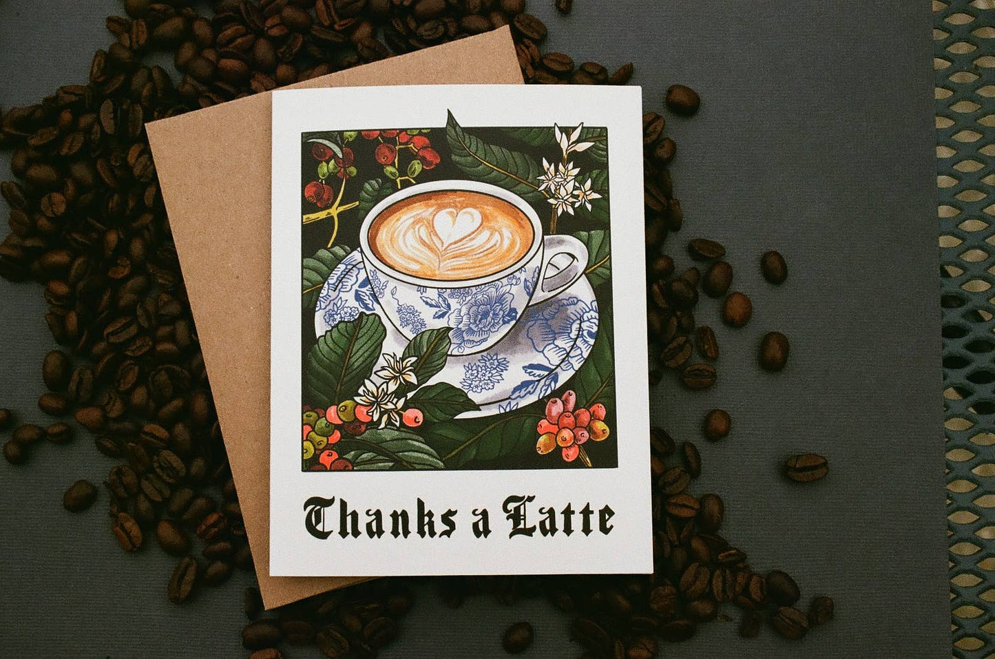 Greeting card with coffee design and 'Thanks a Latte' text, surrounded by coffee beans.