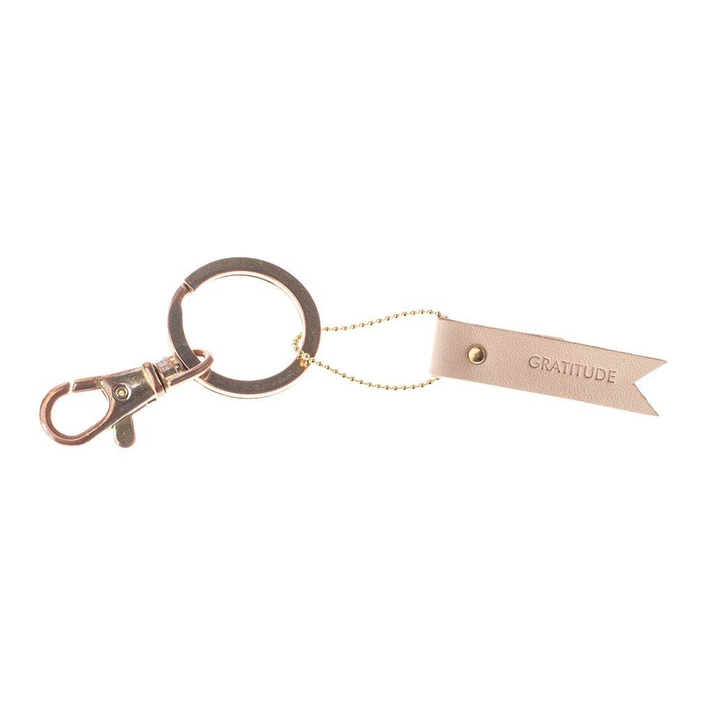 Keychain with a leather tag labeled 'Gratitude' on a white background