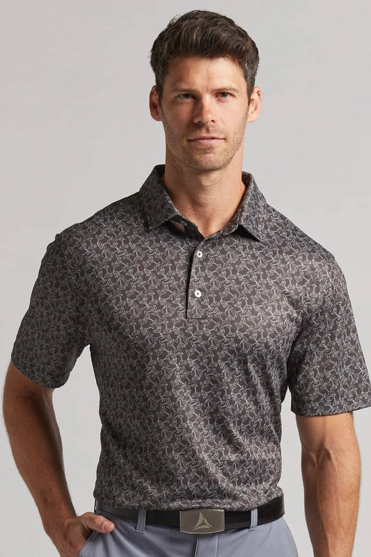 Man wearing a patterned gray polo shirt against a plain background