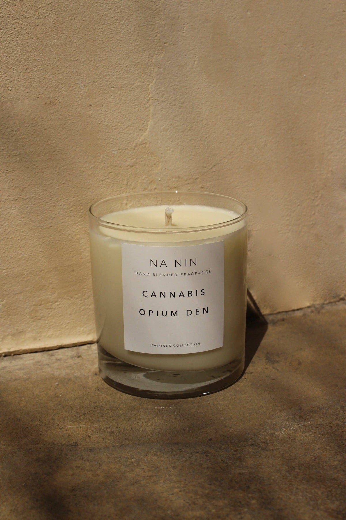 Candle with a label on a textured surface