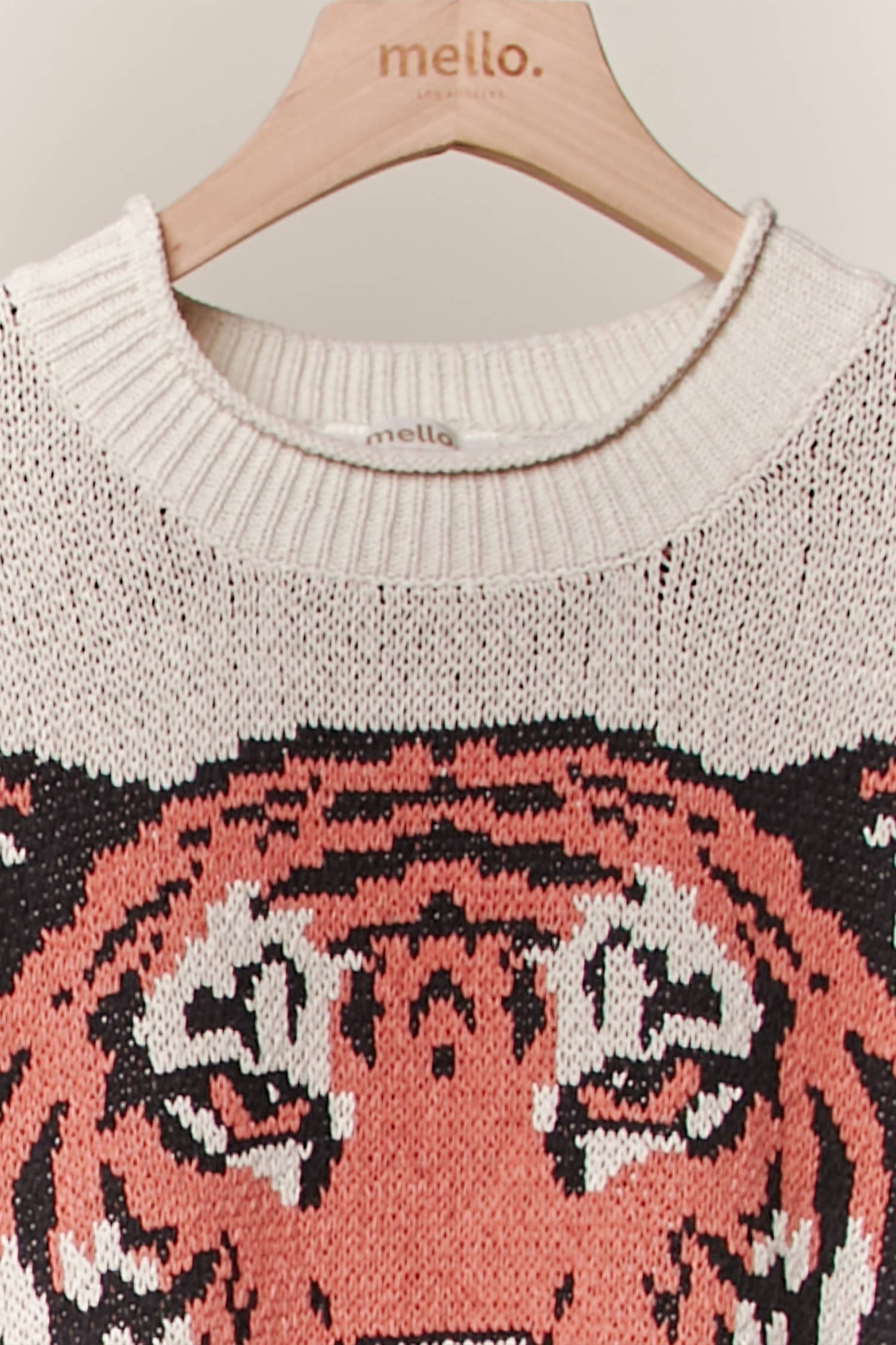 Knitted sweater with tiger design on a hanger