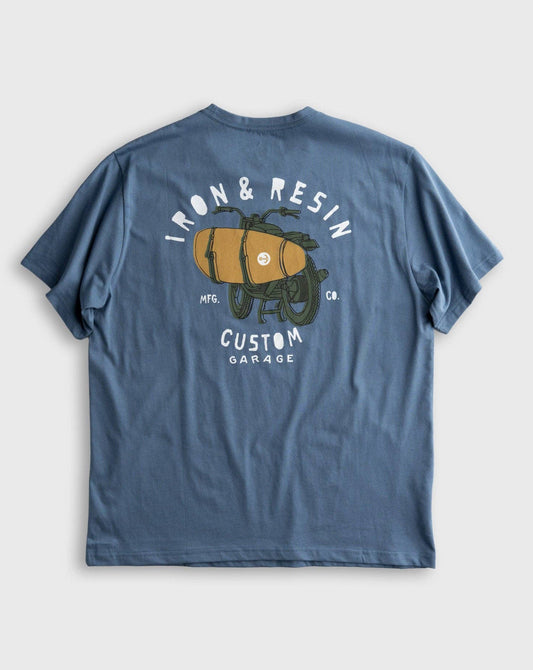 Blue t-shirt with graphic design on the back on a light gray background
