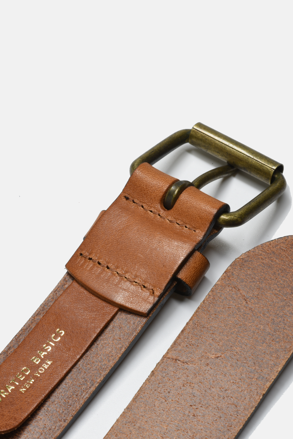 Brown leather belt with brass buckle on a white background