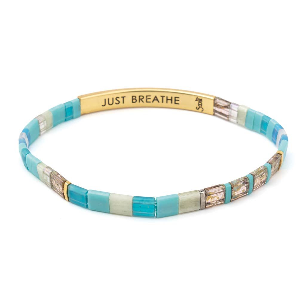 Multicolored beaded bracelet with 'JUST BREATHE' engraving on a white background