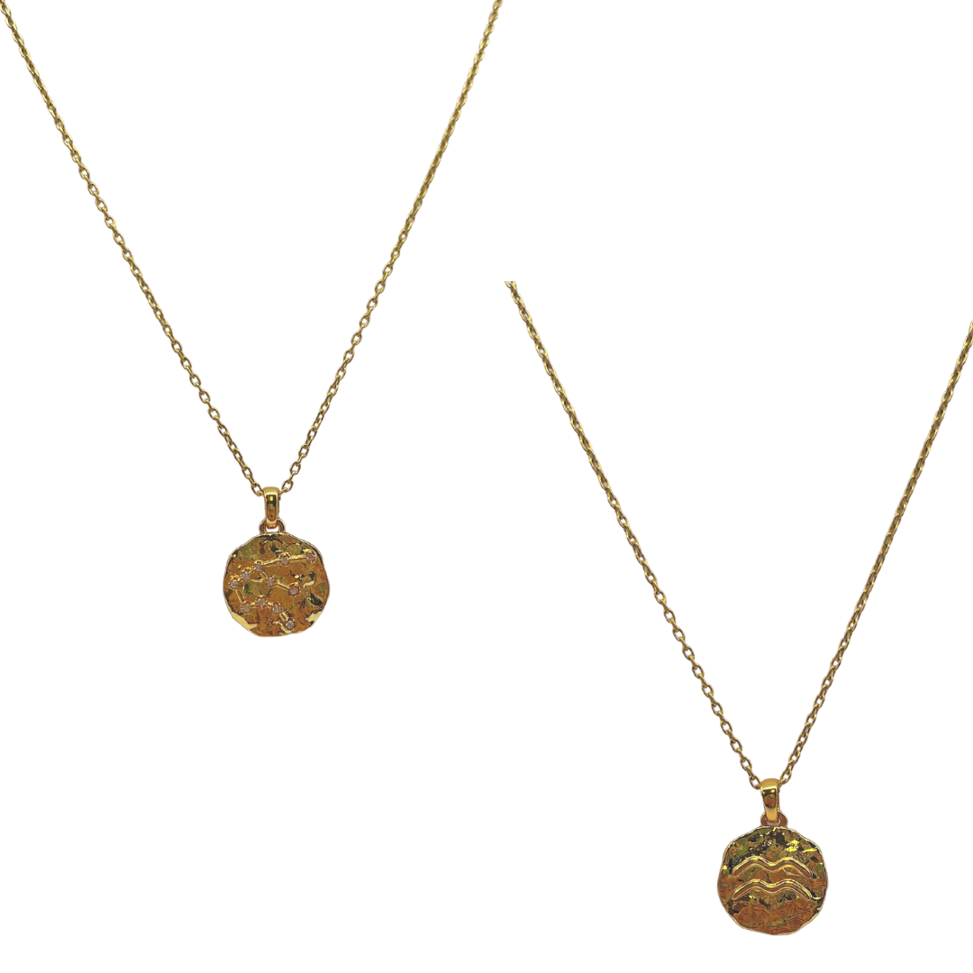 Two gold necklaces with intricate pendants on a white background