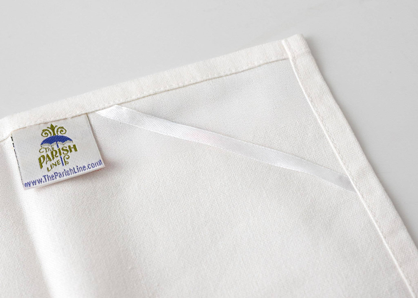 White fabric with a visible brand label on a light gray background