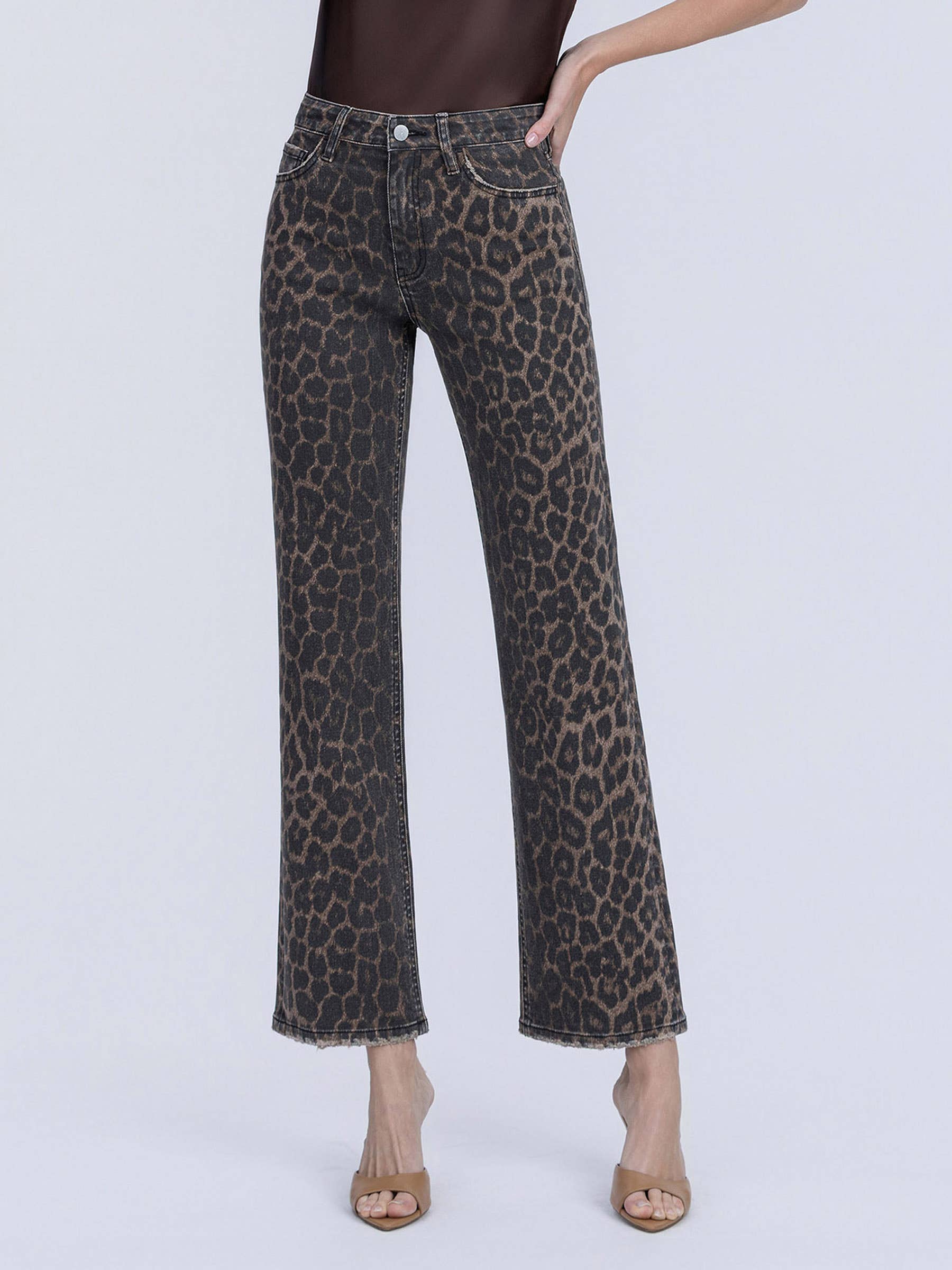 Leopard print jeans worn by a person on a white background