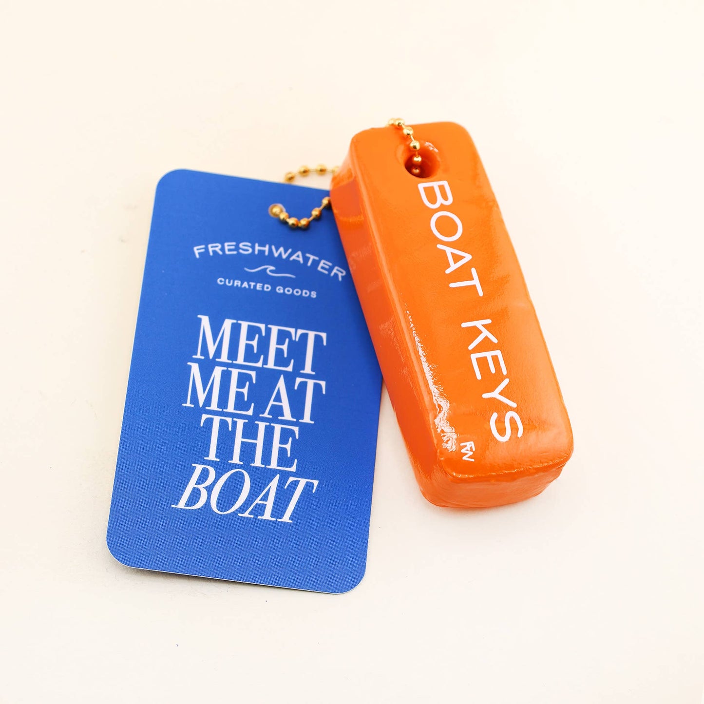 Blue and orange key fobs with text on a white background
