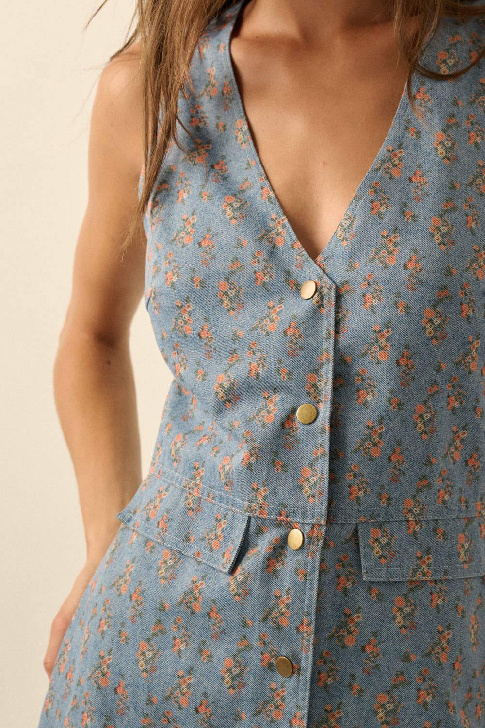 Blue floral dress with button details on a beige background
